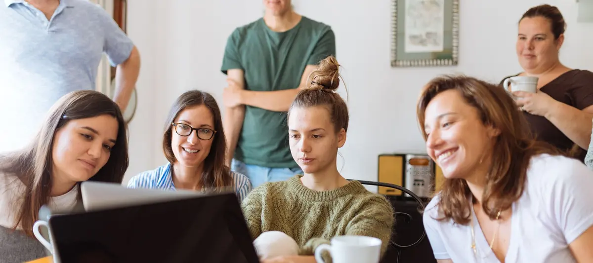 A team working together over documents and a laptop in a modern office — Introducing and supporting Langdock