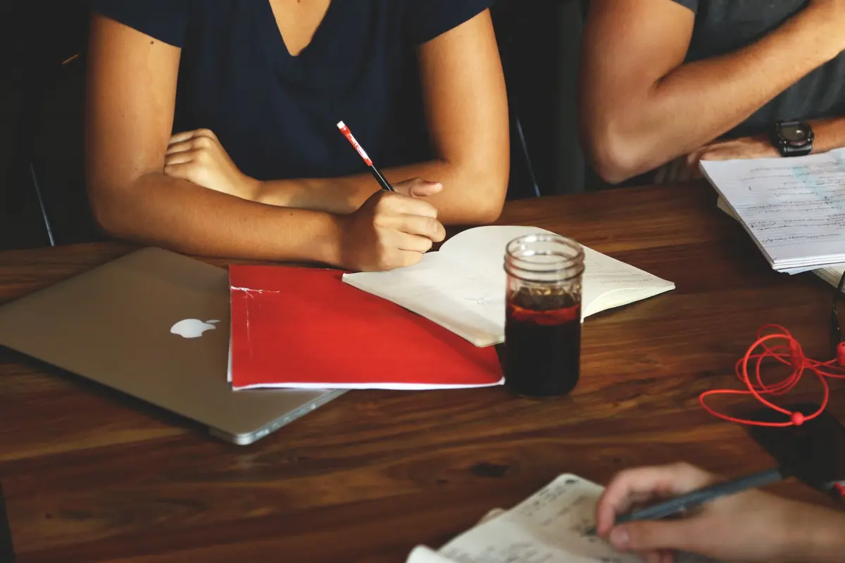 Small team in an office discussing the rollout of an AI platform around a meeting table